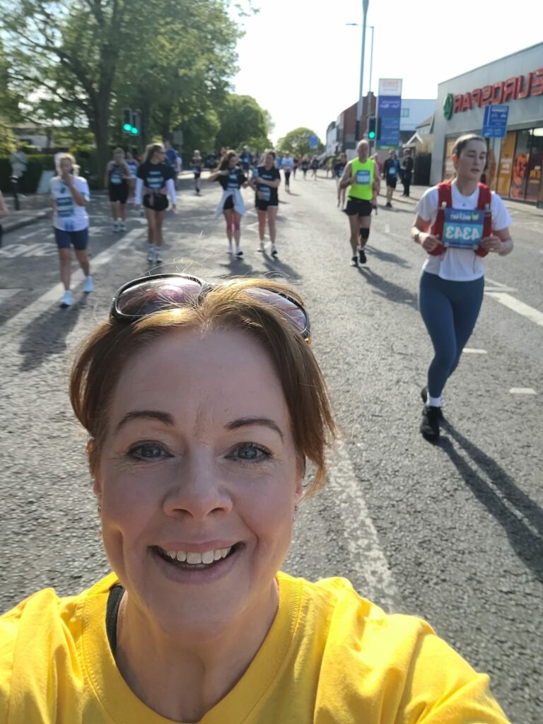 Selfie of Sinead while running the Belfast City Marathon 2025